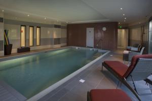 a large swimming pool in a hotel room at Domitys Le Château des Plans in Parthenay