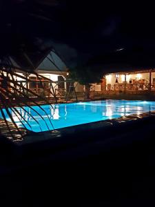 a large blue swimming pool at night at Mimi na wewe villa in Nungwi