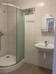 a bathroom with a shower and a sink at VIP hostel in Mukacheve