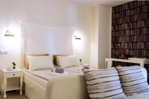 a bedroom with a bed with pillows and a book shelf at Skopje VIP Apartments in Skopje