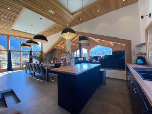 a kitchen and dining room with a table and chairs at Chalet Azalée, Montriond, Morzine, Avoriaz in Montriond +53 photos