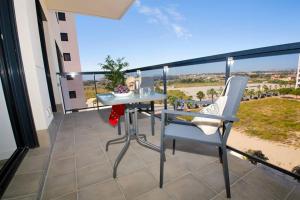 a table and chairs on a balcony with a view at New apartment with AC near the beach in El Campello