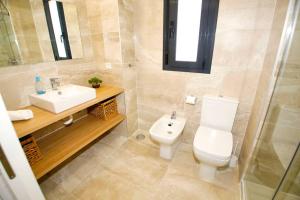 a bathroom with a toilet and a sink at New apartment with AC near the beach in El Campello