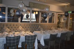 a dining room with white tables and black and white balloons at The County Hotel in Hexham