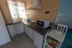 a small kitchen with a microwave on a counter at Edificio Prieto VIV 2 in Puerto del Rosario