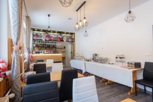 a dining room with a counter and chairs at Villa Zarra in Habovka