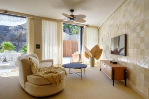 a living room with a chair and a table at 11 Holiday Homes in San Miguel de Abona