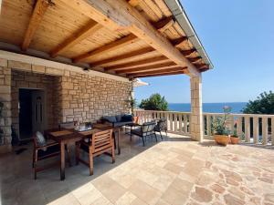 a patio with a wooden pergola and a table and chairs at Casa Fortuna in Sveta Nedelja