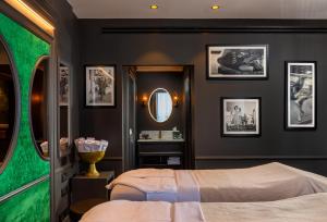 a bedroom with a bed and a mirror at Debrah Brown, a member of Brown Hotels in Tel Aviv
