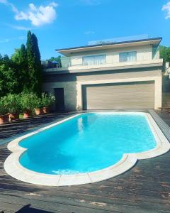 a swimming pool in front of a house at White Luxury Villa Esztergom in Esztergom