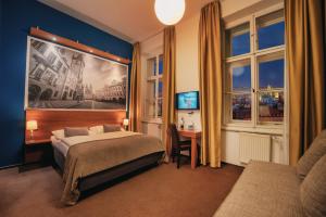 a bedroom with a bed and a painting on the wall at Metropolitan Old Town Hotel - Czech Leading Hotels in Prague