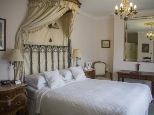 a bedroom with a large bed with a canopy at Albert & Victoria Guest House in Eastbourne