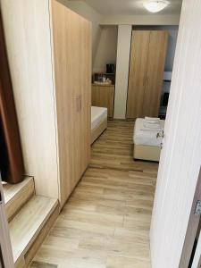 a small room with a bathroom with a bed and a door at Melia Mar in Sozopol