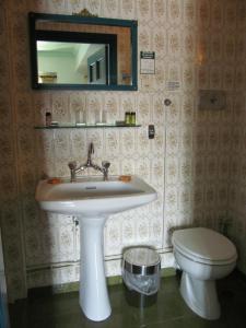 a bathroom with a sink and a toilet at Hotel Aliki in Symi