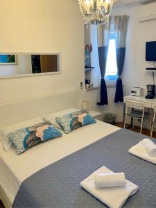 a bedroom with a bed with two pillows on it at Apartment and room Sveti Jakov in Dubrovnik