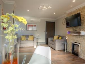 a living room with a couch and a fireplace at Remaotel The Bromley Apartments in Great Yarmouth