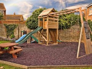 a playground with a slide and a play structure at Hussar Inn in Margate
