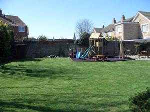 a yard with a playground with a slide at Hussar Inn in Margate