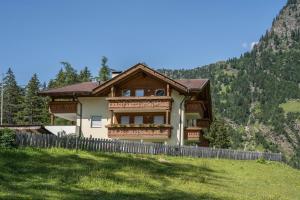 a house on a hill with a fence at Ferienhaus Maria Arnika in Pfelders