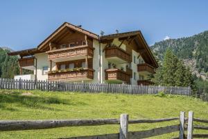 a house on a hill with a wooden fence at Ferienhaus Maria Arnika in Pfelders +12 photos