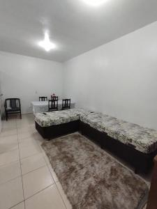 a living room with a large couch on the wall at Apartamento - Anthurium in Joinville