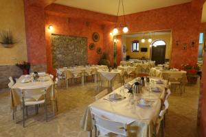 a dining room with white tables and chairs at Antica Dimora Marinelli in Ficarra