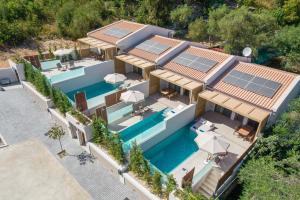 an aerial view of a house with solar panels on the roof at Sivota Kipoi Design Suites in Syvota
