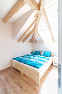 a bedroom with a wooden bed in a attic at Ferienwohnung Bad Camberg - Apartment Goldener Grund in Bad Camberg