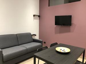 a living room with a couch and a table at Dimore Albrunè in Catania