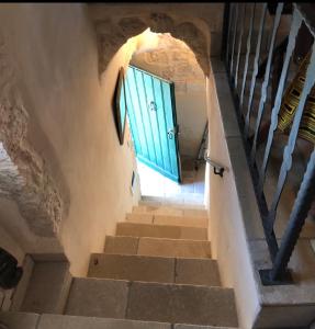 a stairway with a blue door in a building at Casa Federico in Ostuni