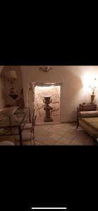 a room with a table and chairs and a light at Casa Federico in Ostuni