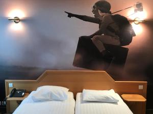 a person jumping in the air over two beds at Liberty in Blankenberge