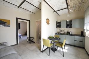 a kitchen and living room with a table and chairs at La Cascina di Chiara in San Martino sulla Marruccina