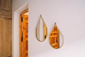 a pair of mirrors hanging on a wall at Ronda City Wall Apartments with Private Pool in Ronda