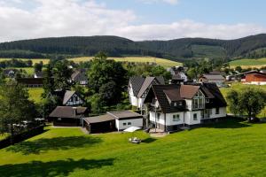 an aerial view of a house in a green field at Ferienwohnung Darge in Schmallenberg