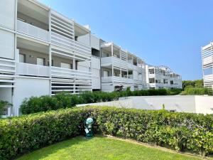a parking meter in the grass in front of a building at Appartamento Laguna - Carraro Immobiliare Jesolo - Family Apartments in Lido di Jesolo
