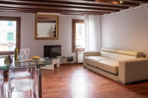 un soggiorno con divano e tavolo di Appartamenti Superior in Via Garibaldi by Bricola Apartments a Venezia