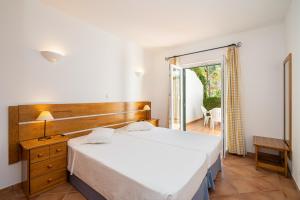 En eller flere senge i et værelse på Quinta do Morgado - Apartamentos Turisticos Monte Da Eira