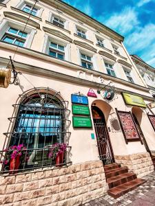 a building with a sign on the front of it at Schronisko Młodzieżowe PTSM "Alko" in Rzeszów