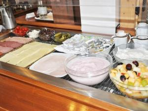a counter top with a bunch of food on at Hotel Ulmer Stuben in Ulm