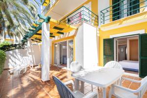 a patio with a white table and chairs at Quinta do Morgado - Apartamentos Turisticos Monte Da Eira in Tavira