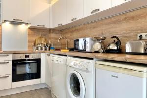 a kitchen with a washer and dryer at #M0 Le charme voironnais T3 6 persons City center in Voiron +12 photos
