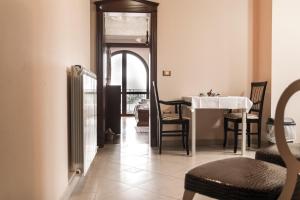 a dining room with a white table and chairs at Apartments Leonarda in Portorož
