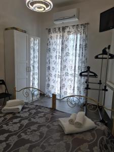 a bedroom with a bed with towels on it at Beautiful Naxos House in Giardini Naxos +70 photos