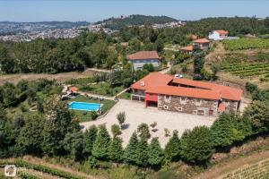 an aerial view of a house with a swimming pool at Quinta da Urtigueira in Felgueiras