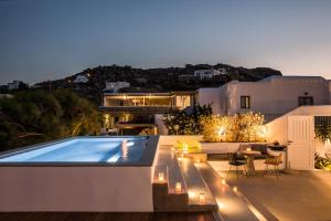 a house with a swimming pool at night at Amyth of Mykonos Super Paradise in Super Paradise Beach