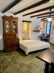 a bedroom with a bed and a wooden cabinet at SAIL house in Skala Kallirakhis