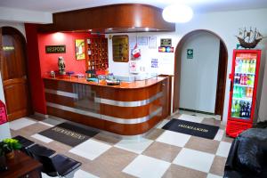 a bar in a restaurant with a checkered floor at Hotel Sol del Sur in Nazca