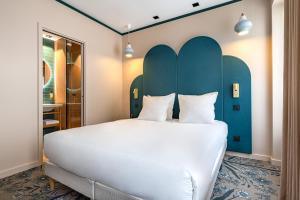Postel nebo postele na pokoji v ubytování O.Lysée Hotel