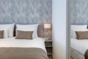 two beds sitting next to each other in a bedroom at Four Blue Seasons - Luxury Apartments Dubrovnik in Dubrovnik